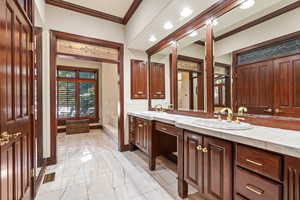 Bathroom with vanity and crown molding