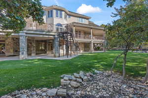 Back of property with a patio area and a lawn