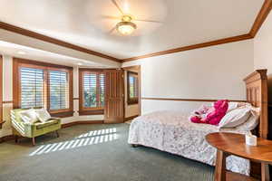 Bedroom with carpet, crown molding, a textured ceiling, and ceiling fan