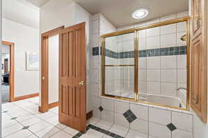 Bathroom with independent shower and bath and tile patterned flooring