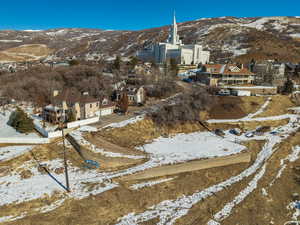 Snowy aerial view featuring a mountain view