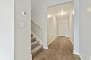 Hall featuring a textured ceiling and light wood-type flooring