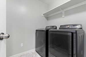 Clothes washing area featuring separate washer and dryer