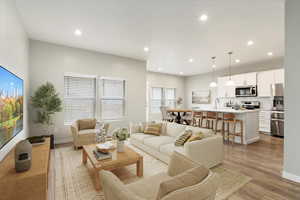 Great Room with light hardwood / wood-style flooring and sink