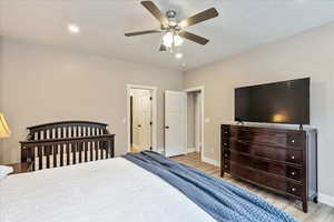 Bedroom featuring ceiling fan and light hardwood / wood-style flooring