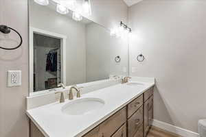 Bathroom with hardwood / wood-style flooring and vanity