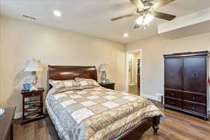 Bedroom with hardwood / wood-style floors and ceiling fan