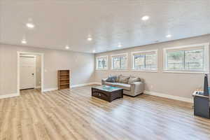 Living room featuring light hardwood / wood-style floors and a textured ceiling