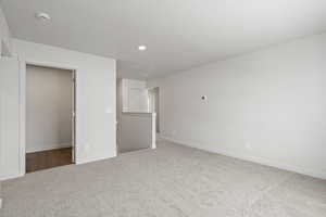 Unfurnished bedroom with carpet flooring, a spacious closet, and a closet