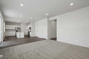 Unfurnished living room with dark colored carpet