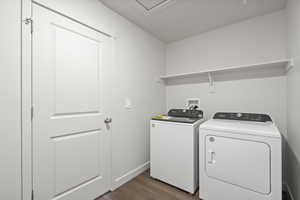 Laundry area with separate washer and dryer and dark hardwood / wood-style floors