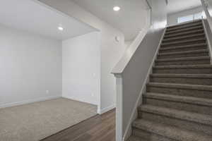 Stairs featuring hardwood / wood-style floors