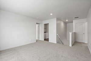 Empty room featuring carpet flooring and washing machine and dryer