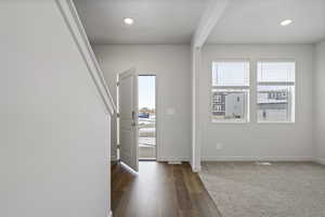 Entrance foyer with dark hardwood / wood-style flooring