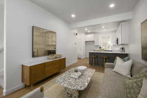 *Model Home Photo. Living room featuring light hardwood / wood-style flooring and sink