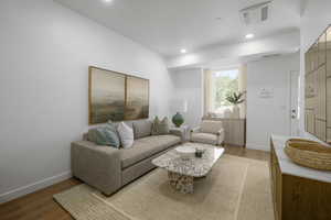 *Model Home Photo. Living room featuring wood-type flooring