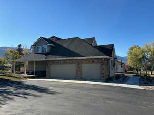 View of front of property with a mountain view and a garage