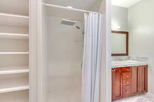 Bathroom featuring vanity and walk in shower