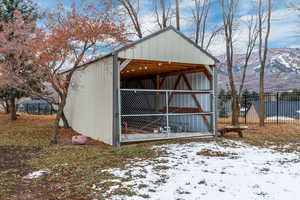 Snow covered structure featuring a mountain view