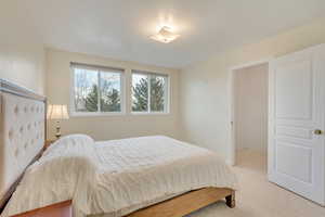 Carpeted bedroom featuring a textured ceiling