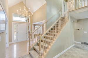 Foyer with high vaulted ceiling and a chandelier