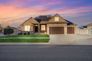 Craftsman house featuring a large yard, a garage, and solar panels
