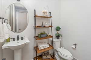 Bathroom with hardwood / wood-style flooring and toilet