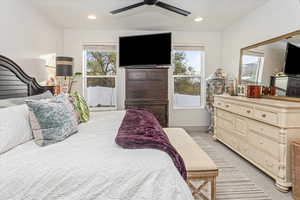 Carpeted bedroom featuring ceiling fan