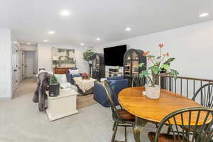 Dining area featuring light carpet