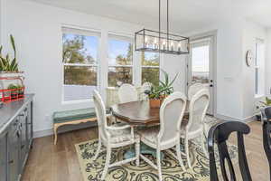 Dining space featuring a chandelier and light hardwood / wood-style floors