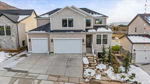 Front of property featuring a mountain view and a garage