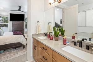 Bathroom with ceiling fan and vanity