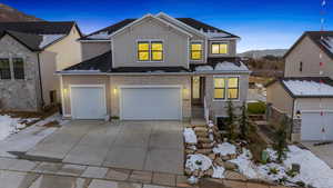 View of property with a mountain view and a garage