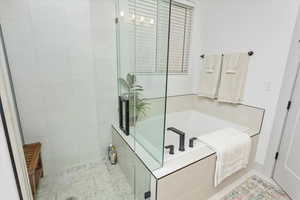 Bathroom with tile patterned flooring and plus walk in shower