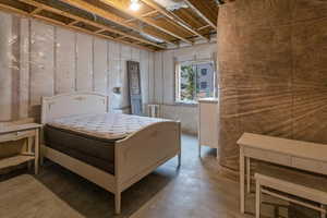 Bedroom with concrete flooring