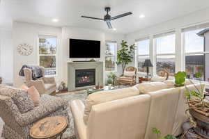 Living room with a wealth of natural light and ceiling fan