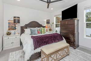 Carpeted bedroom featuring ceiling fan