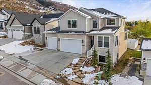 View of front of house featuring a mountain view and a garage