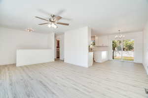 Front/Family Room, featuring ceiling fan and beautiful light solid surface flooring. View to the Dining area. View to the Kitchen. View to the backyard.