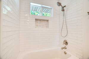 Bathroom featuring tiled shower / bath combo