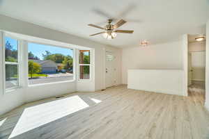 Front/Family Room, featuring ceiling fan and beautiful light solid surface flooring.