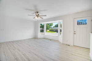 Front/Family Room, featuring ceiling fan and beautiful light solid surface flooring.