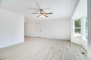 Front/Family Room, featuring ceiling fan and beautiful light solid surface flooring.