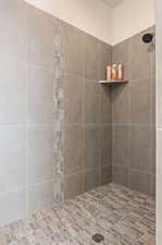 Bathroom featuring a tile shower