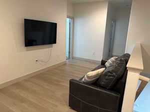 Living room with light hardwood / wood-style floors