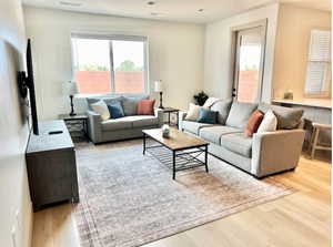 Living room with light hardwood / wood-style floors