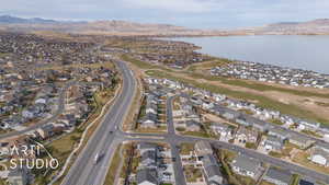 Drone / aerial view featuring a water and mountain view