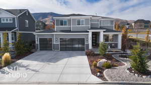 View of front facade with a mountain view and a garage