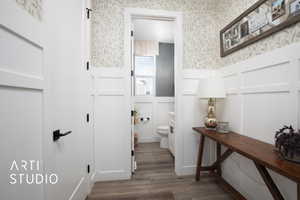 Bathroom featuring wood-type flooring and toilet