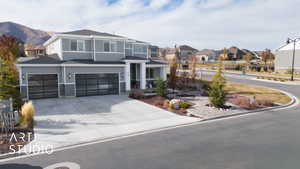 View of front of house with a mountain view and a garage